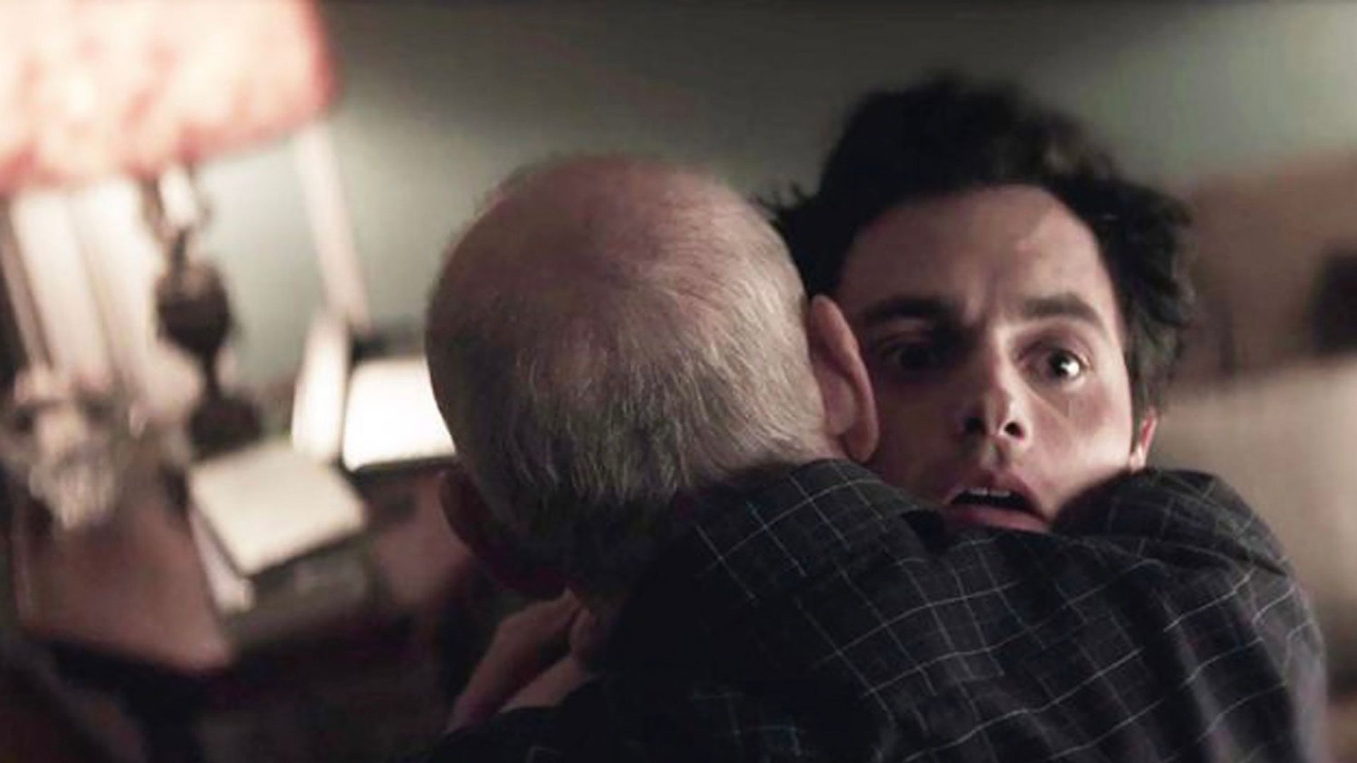 Ivan hugging a stunned and scared Joe in a flashback scene in You.
