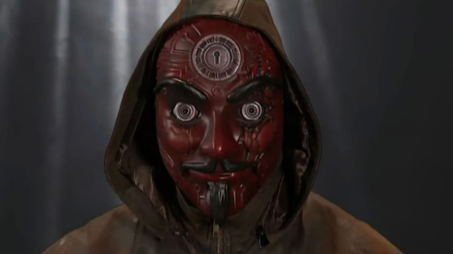 Mastermind from Big Brother 27 staring into the screen with a mask on.