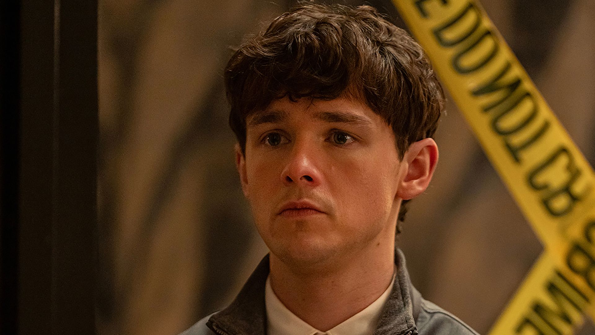 Harrison looking scared standing by caution tape in Dexter: Resurrection