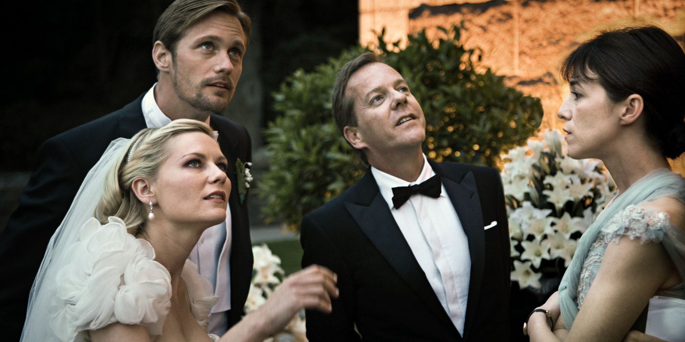 The cast of Melancholia standing outside after a wedding and looking up at the sky.