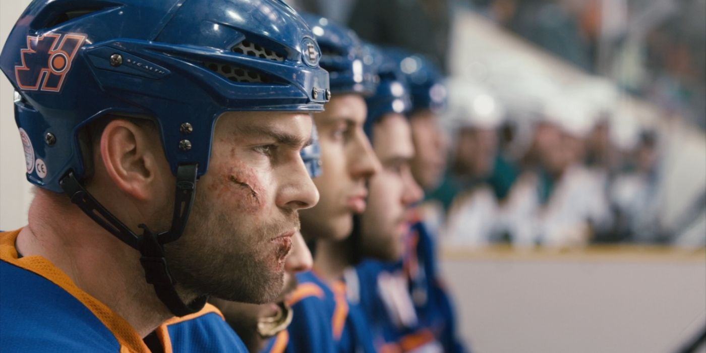 Sean William Scott in Goon with a cut on his cheek as he sits on the bench in a hockey uniform