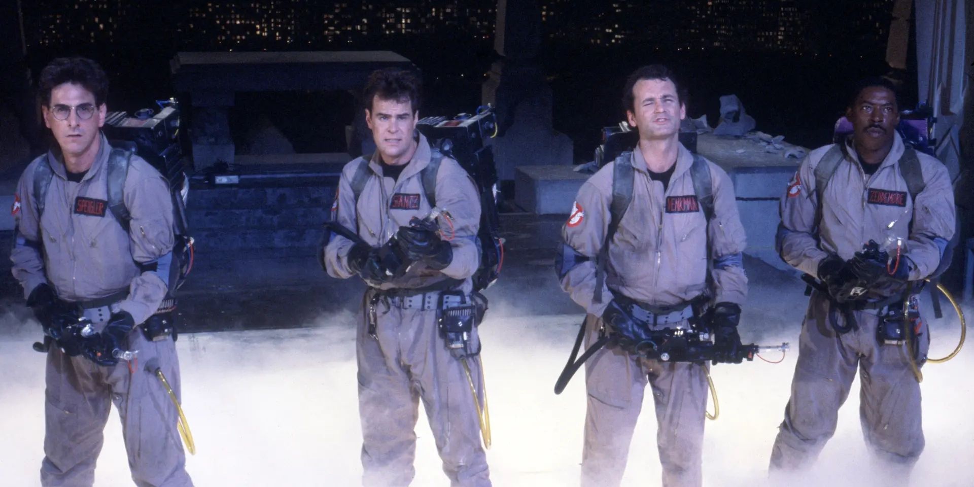 The cast of Ghostbusters standing together in their uniforms