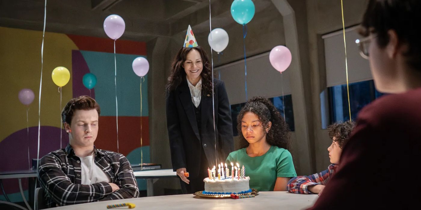 Ms. Sigsby presents a birthday cake in The Institute