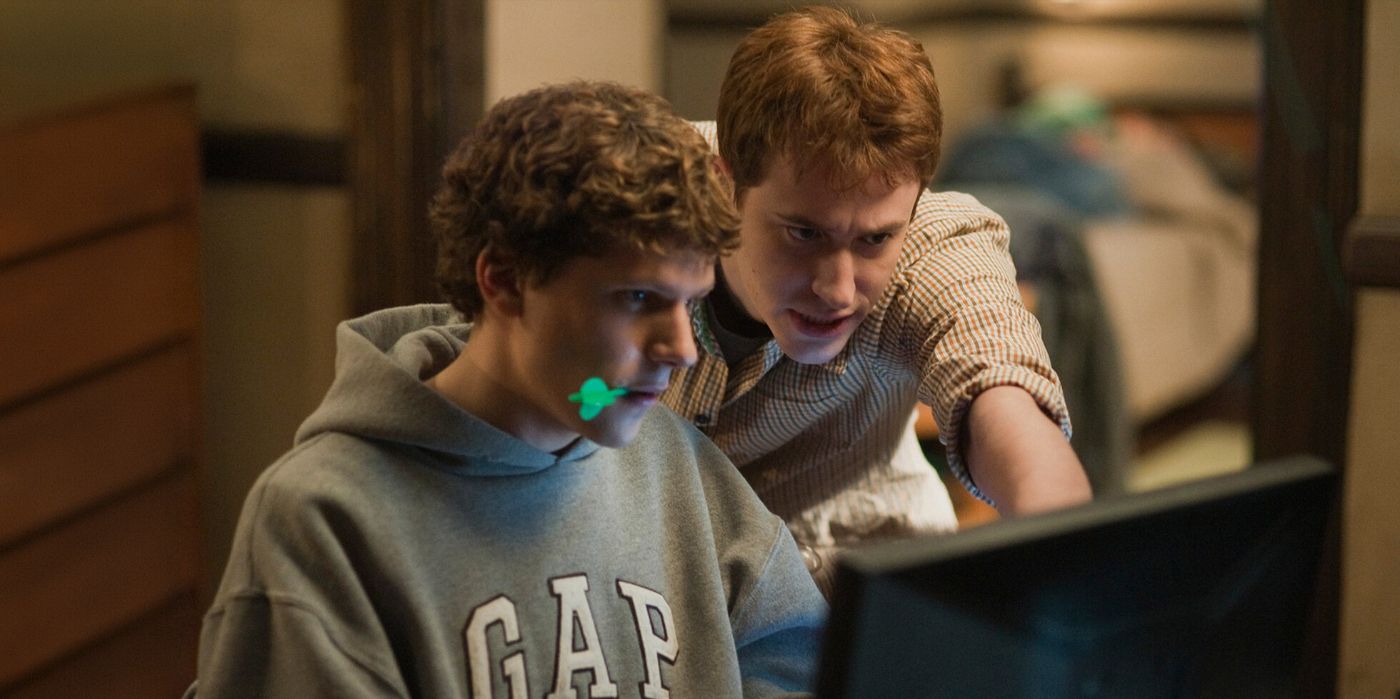 Mark holds a dart in his mouth in The Social Network