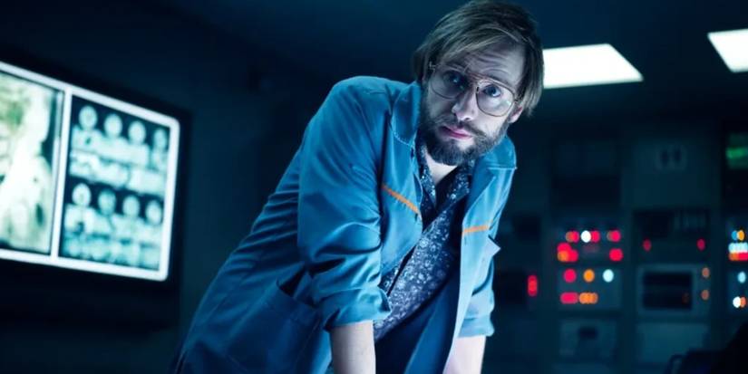 Arthur leans over a desk in Alien: Earth