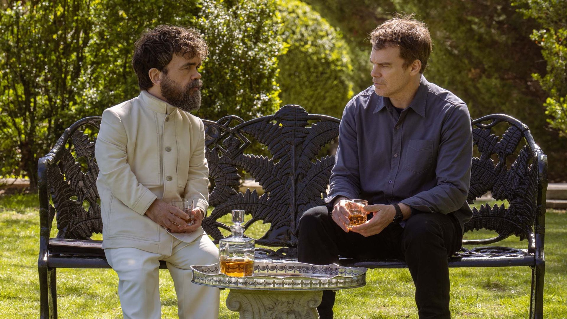 Leon an Dexter talking together on a park bench in Dexter: Resurrection.