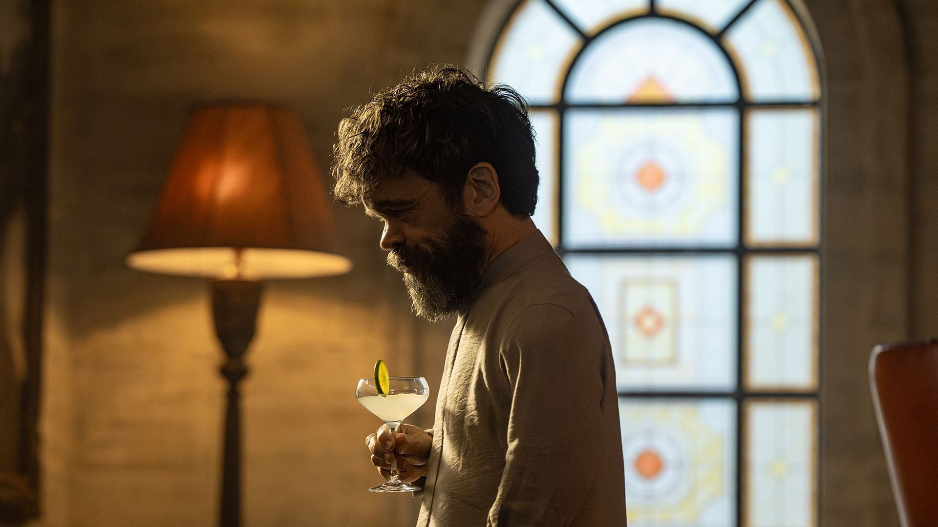 A side profile of Leon drinking a cocktail in Dexter: Resurrection