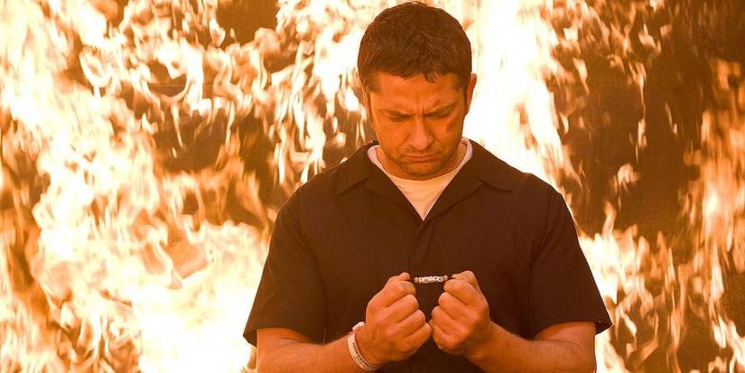 Gerard Butler in Law Abiding Citizen with fire behind him