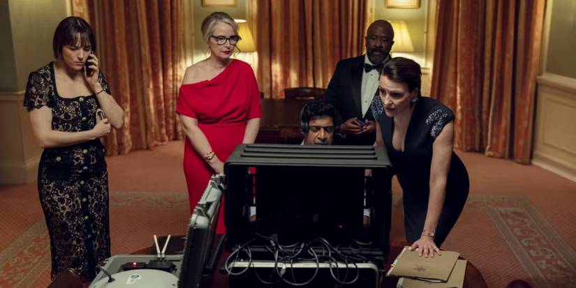 A scene from Hostage with the cast looking at a device