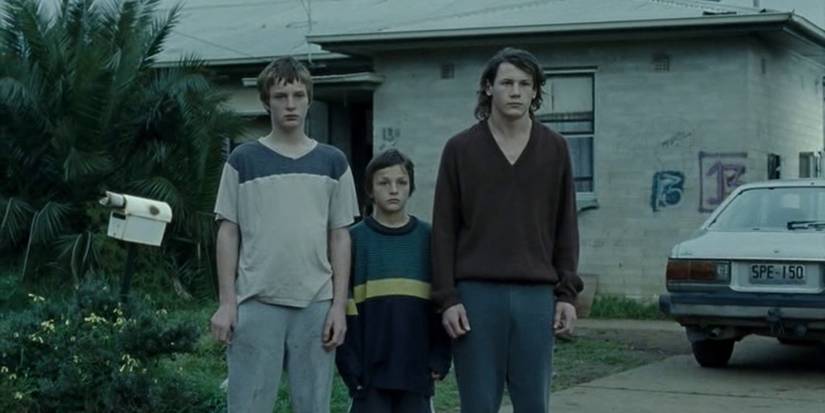 jamie and his brothers in snowtown standing outside looking off-screen