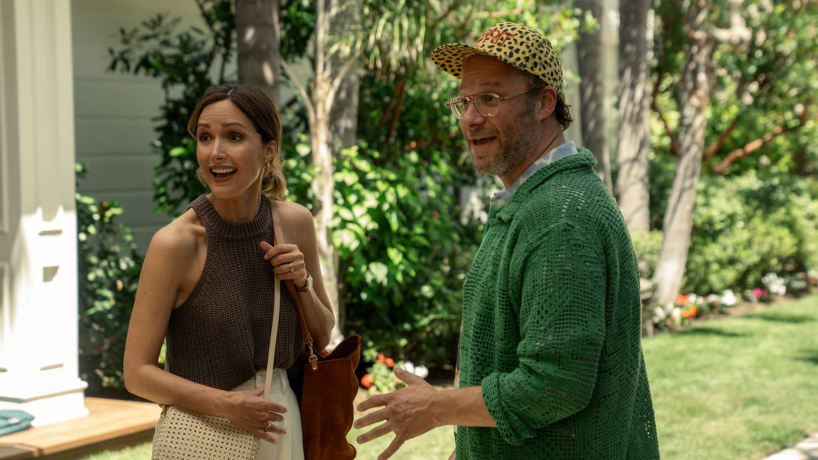 Sylvia and Will smiling at someone outside in Platonic.