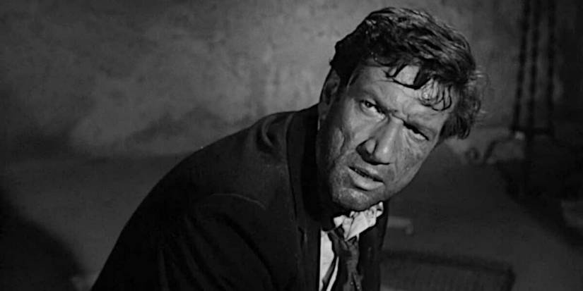 Richard Boone crouched down in I Bury the Living