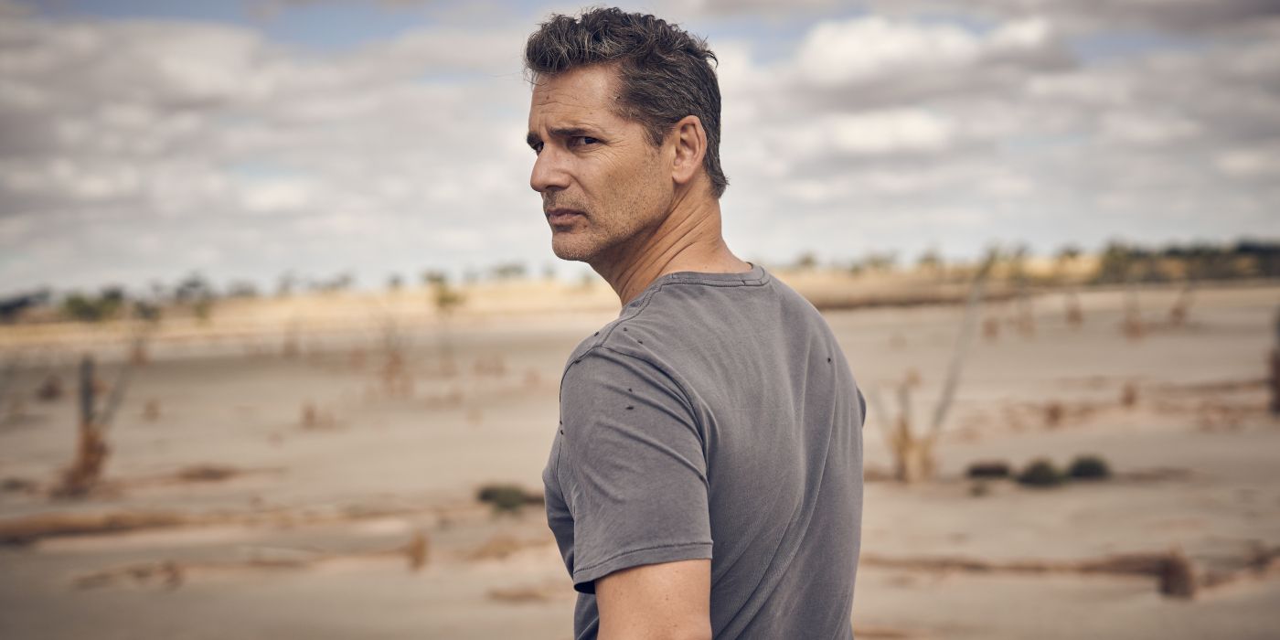 Eric Bana outdoors looking over his shoulder in The Dry