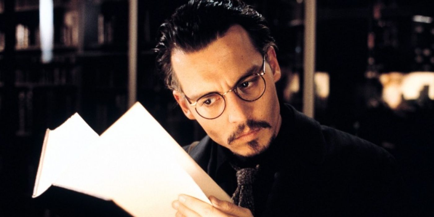 Johnny Depp turning the pages of a book in The Ninth Gate