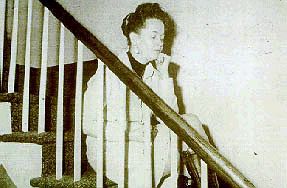Movie PictureLorraine Warren, back in the day, collapsing on a staircase,