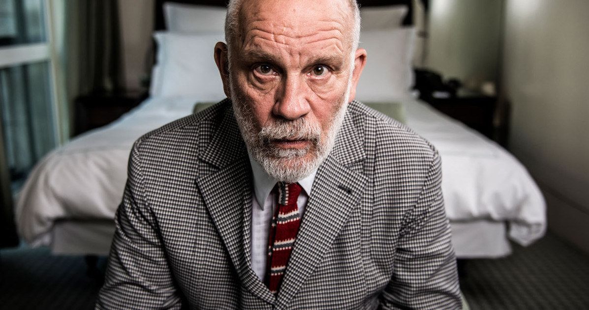 John Malkovich close-up with a beard and nice suit