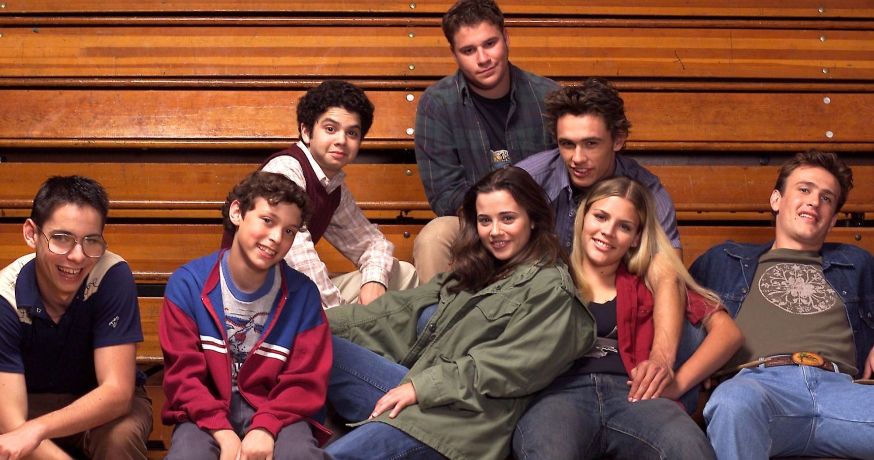  the Cast of Freaks and Geeks sit in the bleachers