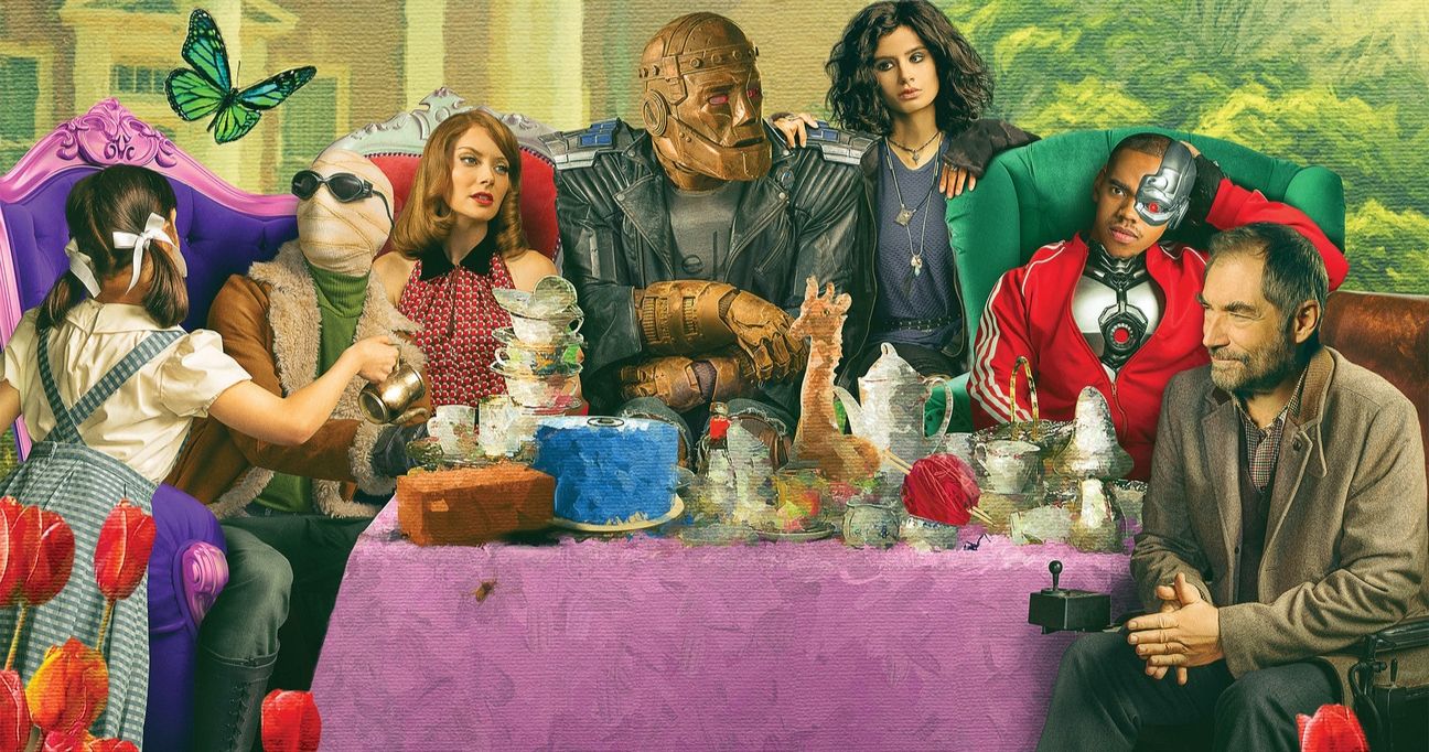The season 2 cast of HBO Max's Doom Patrol sitting at a banquet table.