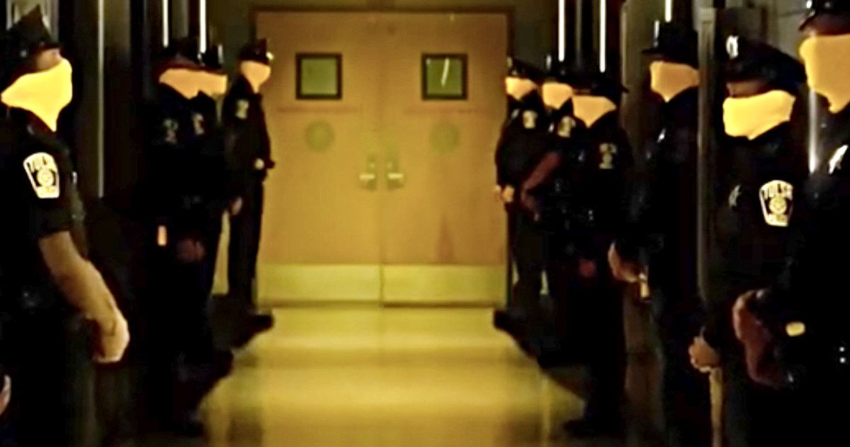Masked Cops stand in a hallway in Watchmen