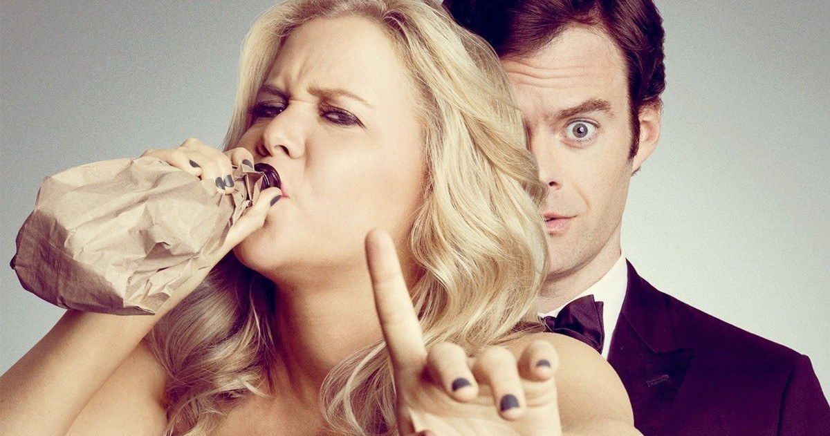 Amy Schumer drinking from a brown bag next to Bill Hader in Trainwreck