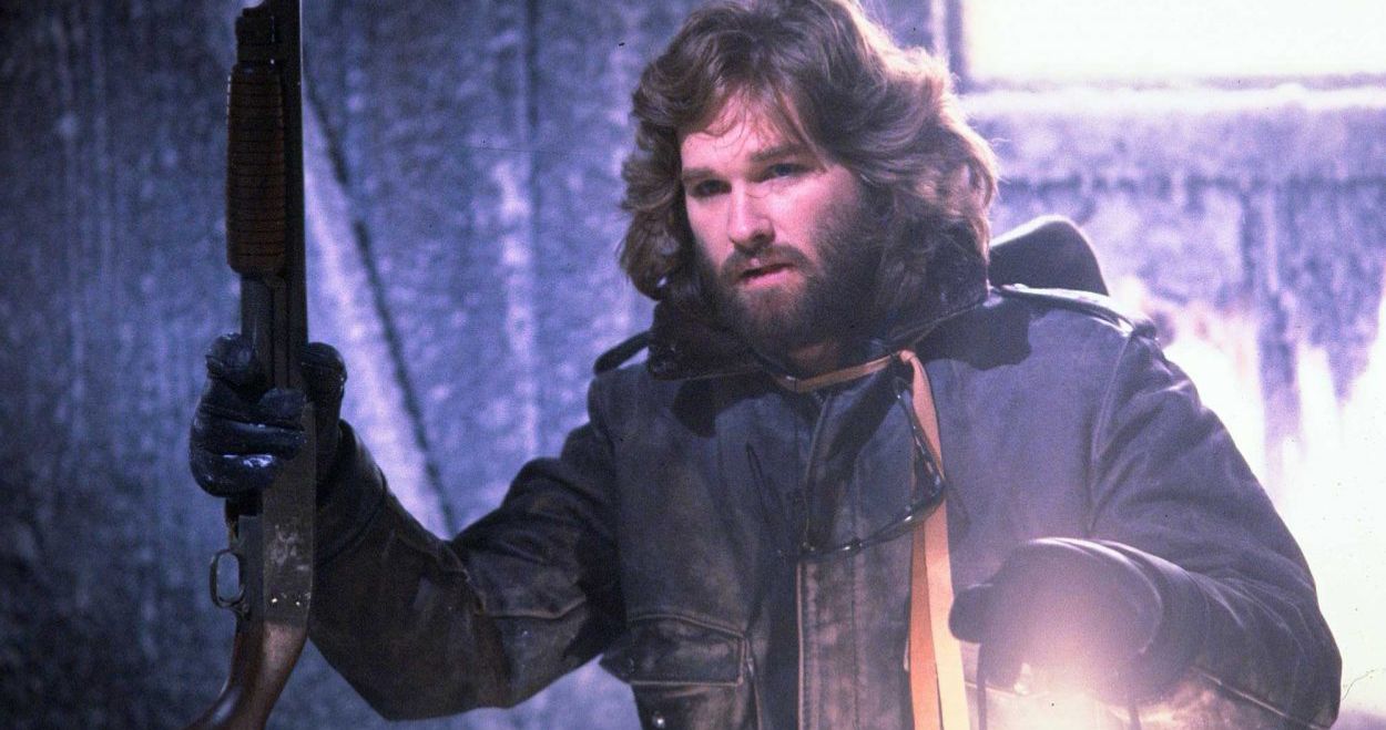 Kurt Russell looks in a cave in The Thing