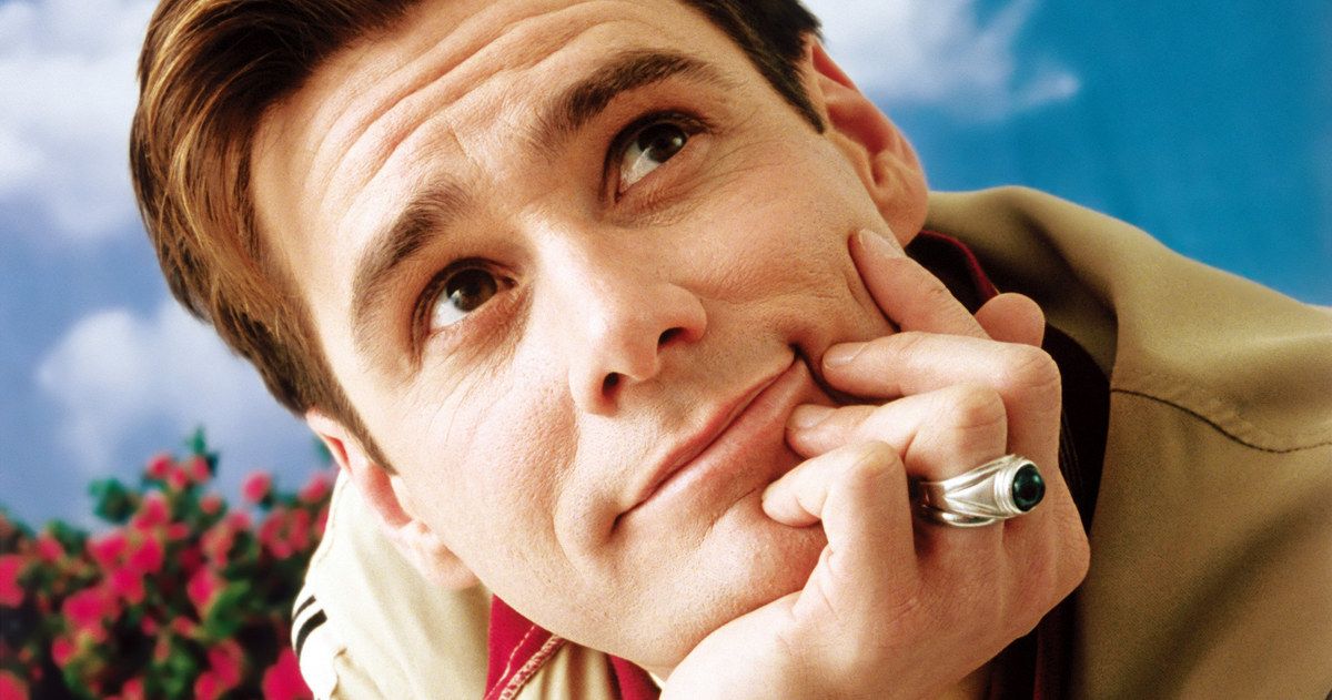 The Truman Show star Jim Carrey smiles and rests his head on his hands