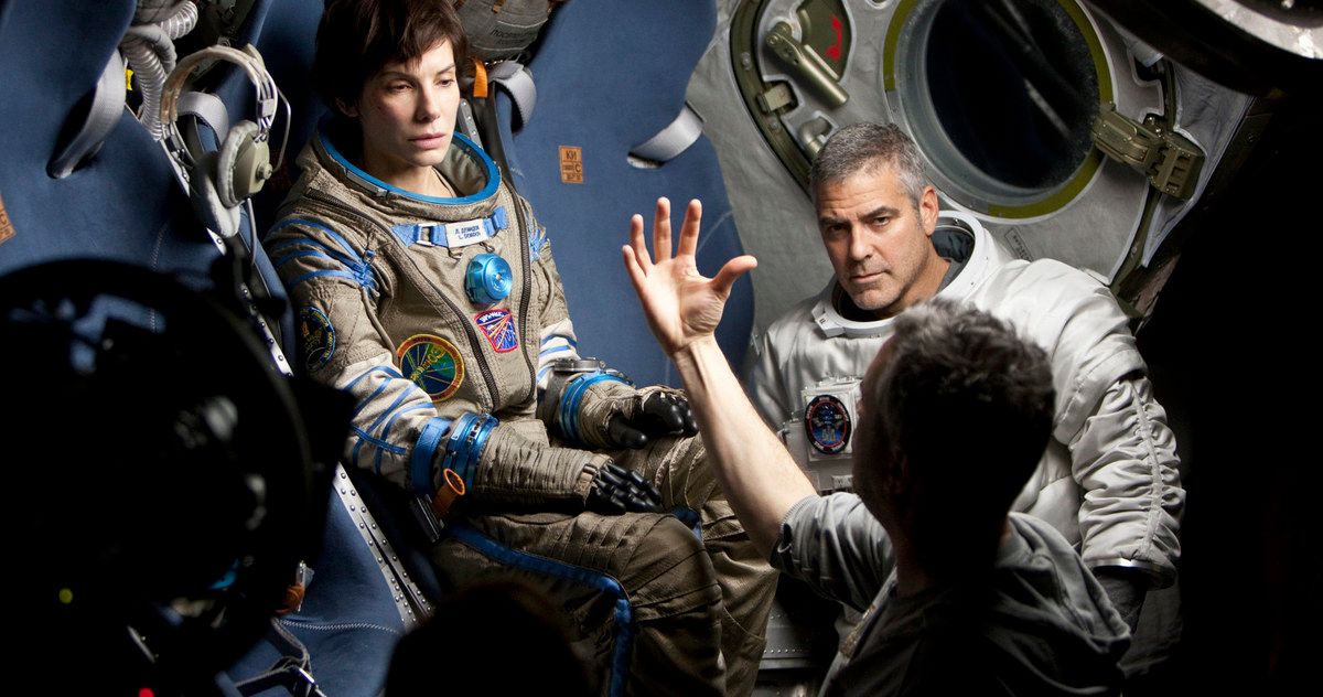 Alfonso Cuaron directing George Clooney and Sandra Bullock in a tiny shuttle on the set of Gravity