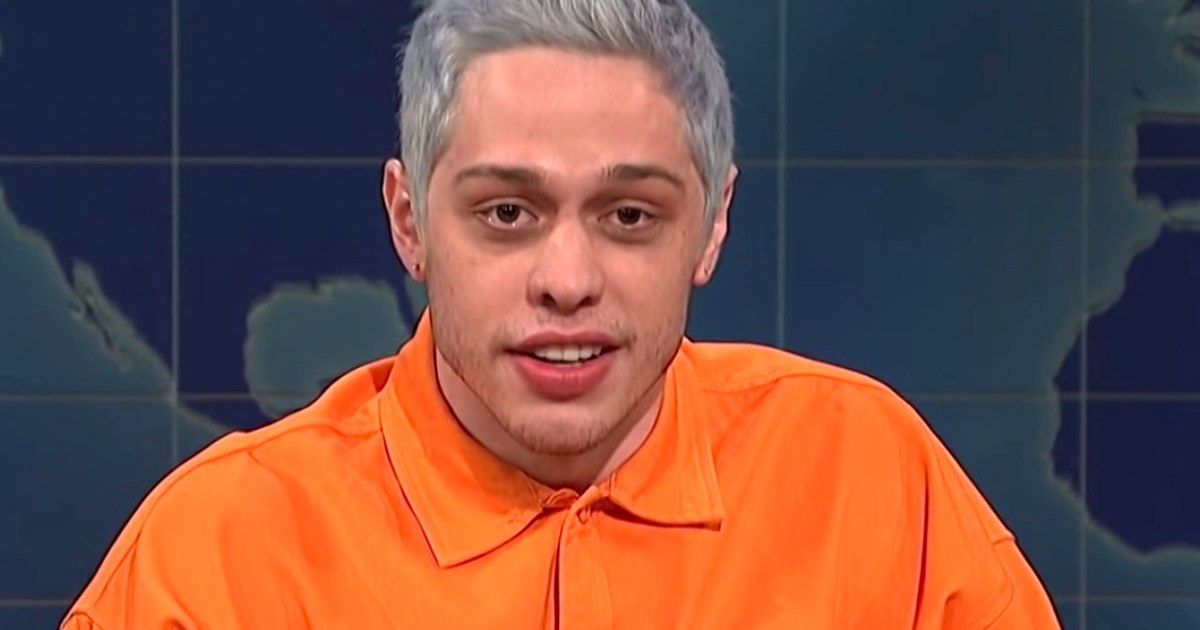 Pete Davidson on the Weekend Update Segment of SNL wearing an orange shirt