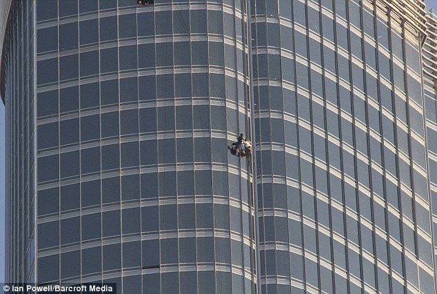 Tom Cruise and another actor in action on the Mission: Impossible Ghost Protocol set