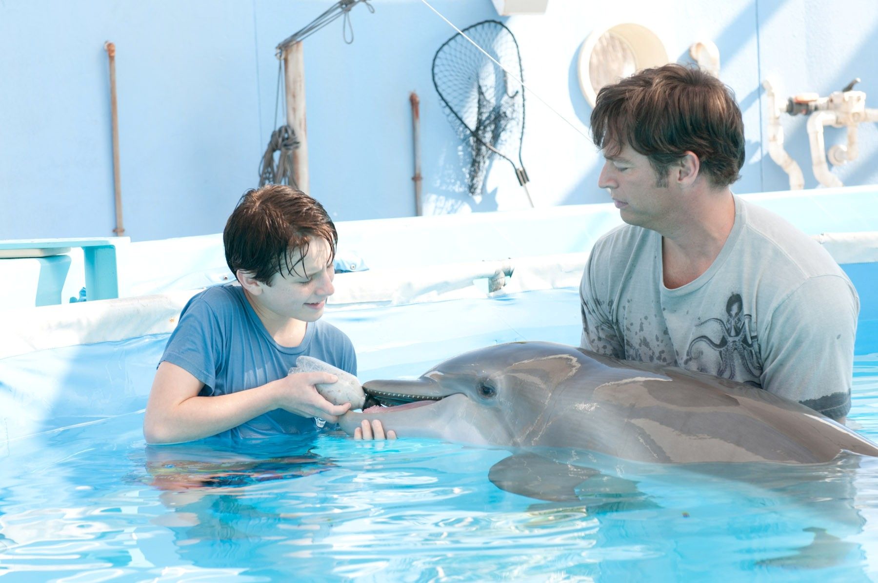 Nathan Gamble and Harry Connick Jr. share a scene with WinterFinally, we asked Morgan Freeman if he has had an opportunity to have any interaction with Winter the dolphin. Only a little, he answered. I noticed when I got here, you know I've never had any intimate relationships with a dolphin. Horses, dogs, chickens, geese, penguins, and things like that but not fish. So I was trying to ingratiate myself, she's just like a little child. She shies away and then she comes back. Then finally you can