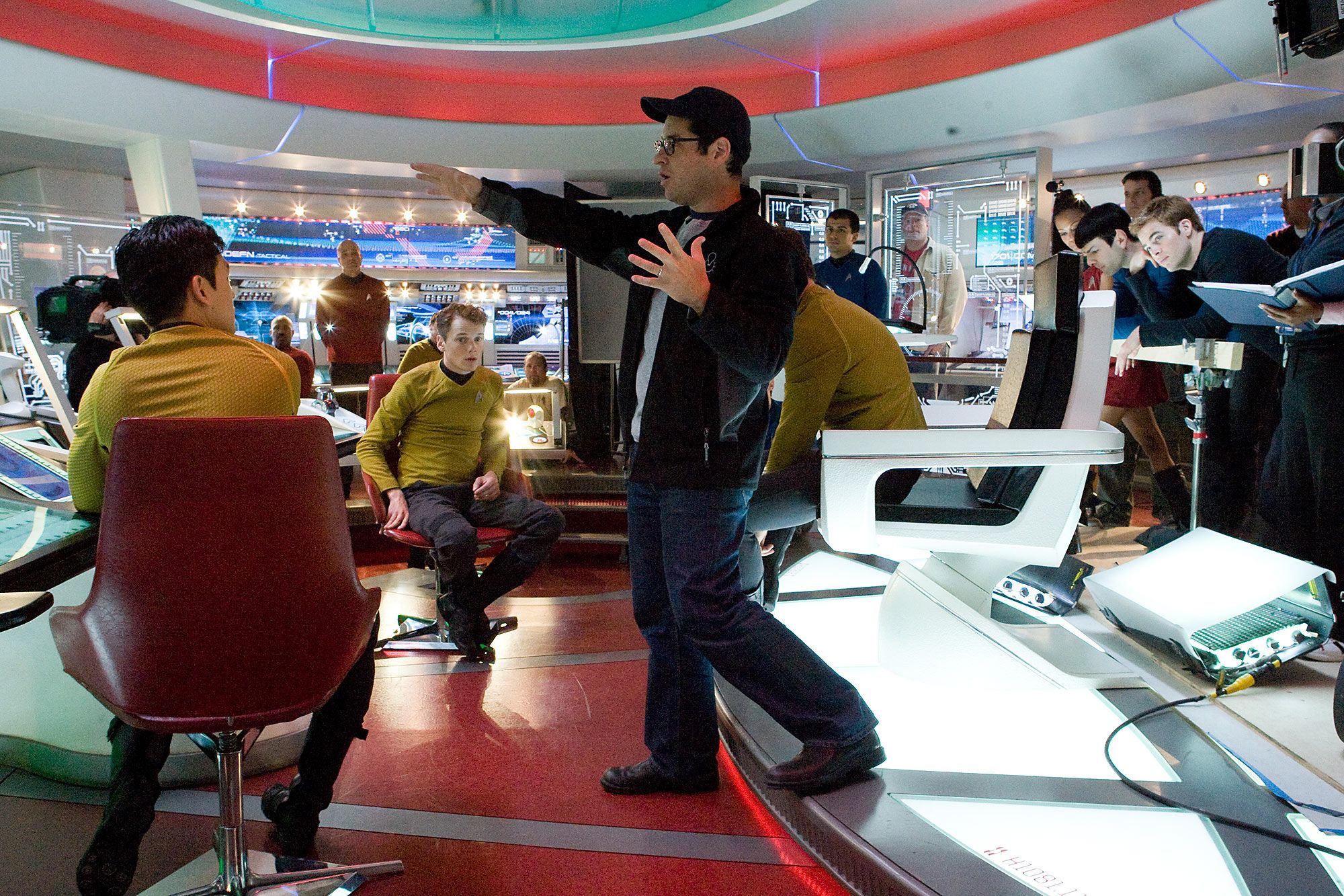 Director J.J. Abrams (center) discusses a scene with actors John Cho (left, as Sulu), Anton Yelchin (center left, as Chekov), Zachary Quinto (center right, as Spock), and Chris Pine (far right, as James T. Kirk) behind-the-scenesIt's a funny thing when we were working on the script, frankly it was one of those moments where I was like, how in the name of God are we going to figure it out. One of the genius moves that Alex (Kurtzman) and Bob (Orci) did is that they just did it, Abrams explained. 