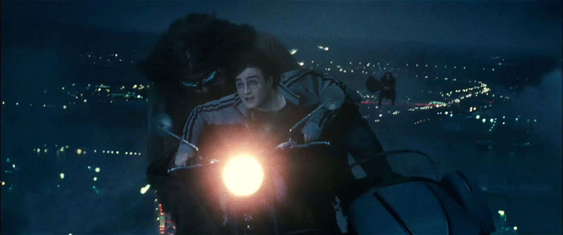 Harry (Daniel Radcliffe) rides with Hagrid (Robbie Coltrane) on his enchanted motorcycle
